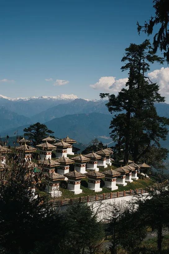 The 108 memorial chortens at Dochula Pass, with the snow-capped Himalayas beyond