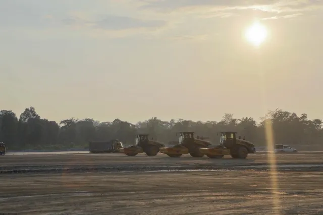 Road rollers compacting the site at sunrise